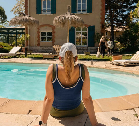 femme assise au bord d'une piscine bleue
